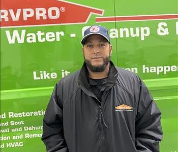 SERVPRO employee in front of green car